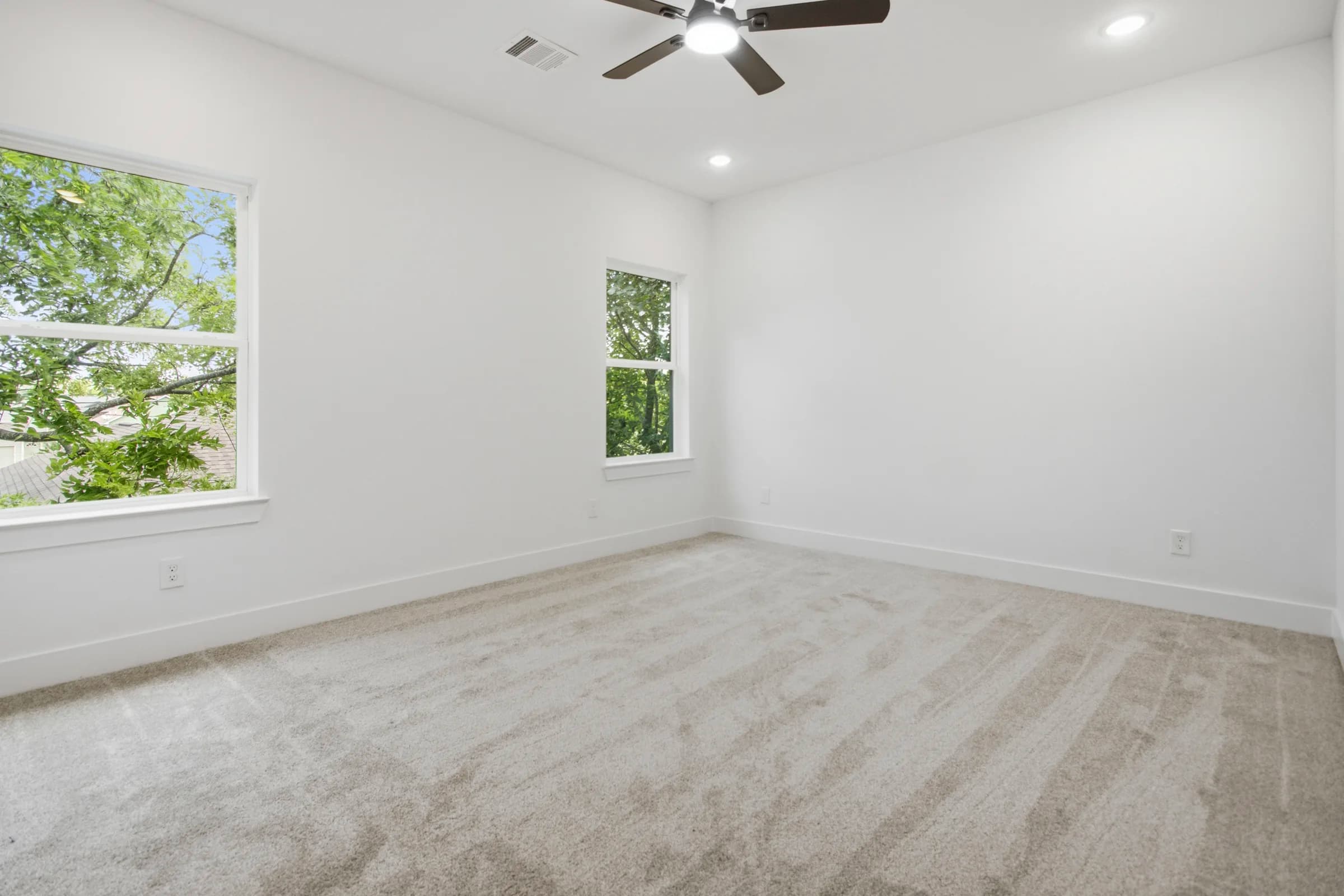 Carpeted bedroom with large windows